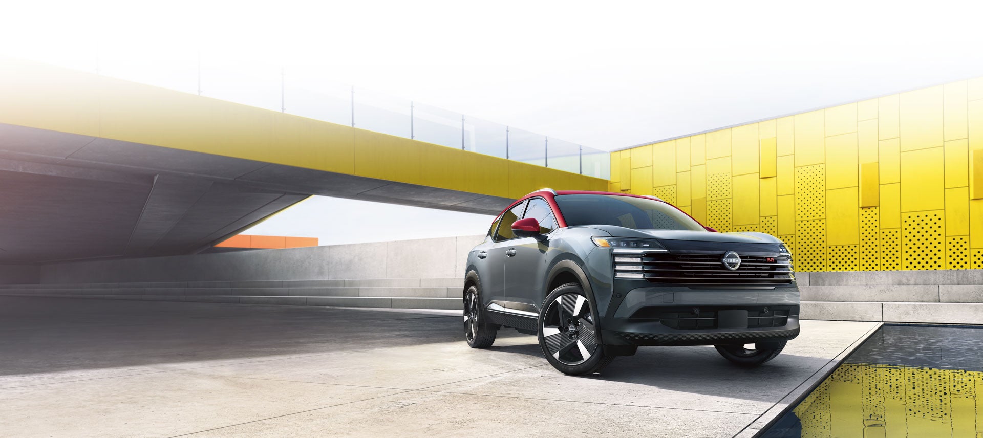 White Nissan Kicks outside yellow building